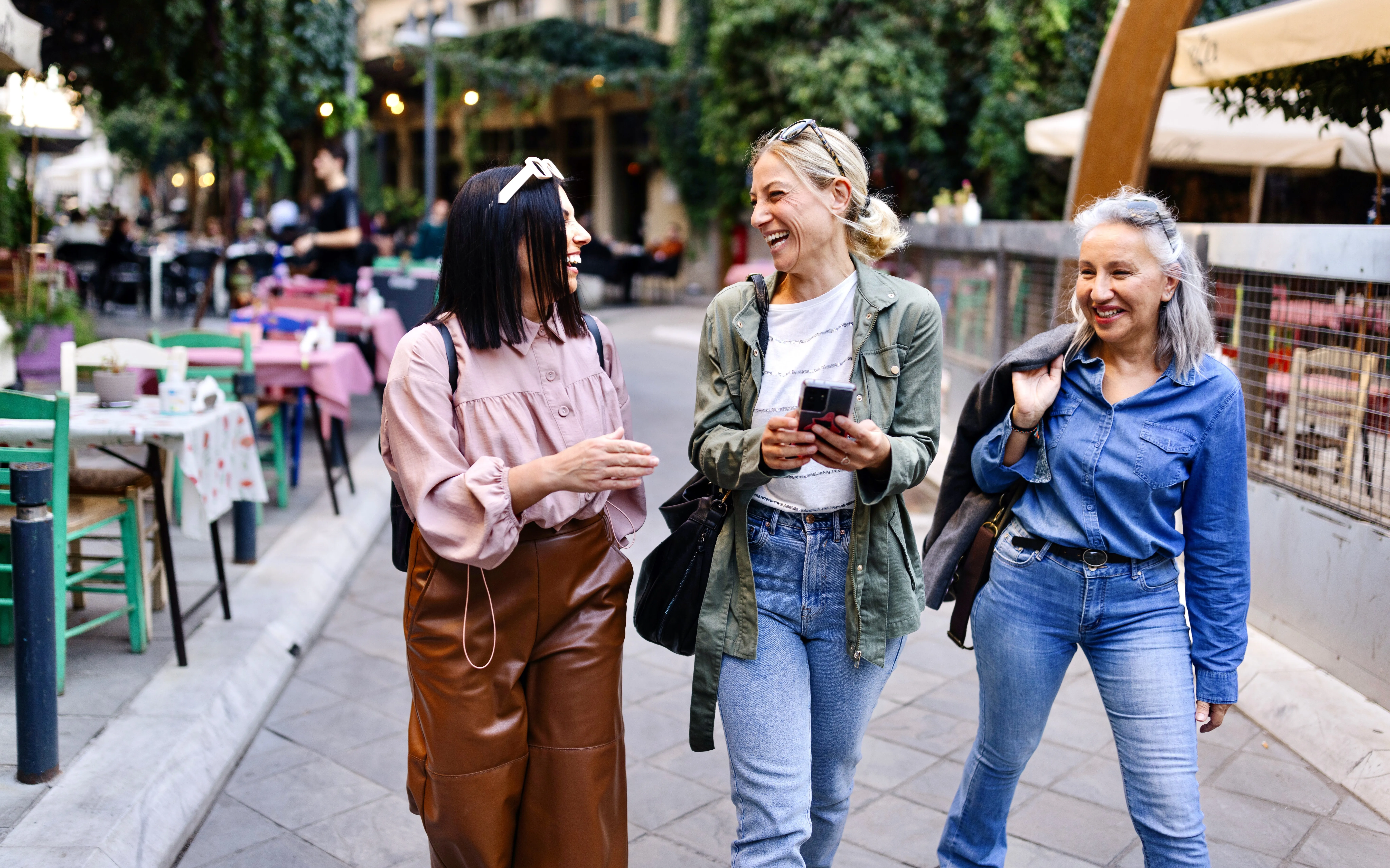 group of girlfriends walking around city