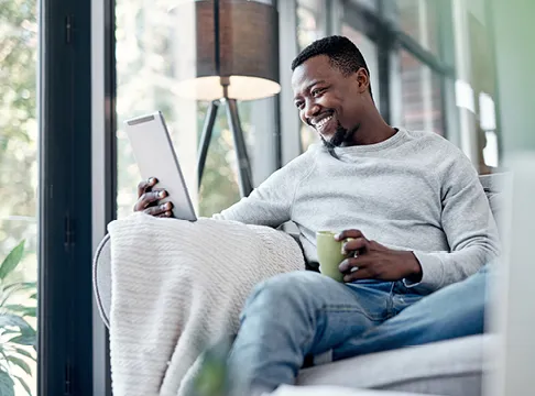 man checking his savings account balance on his tablet