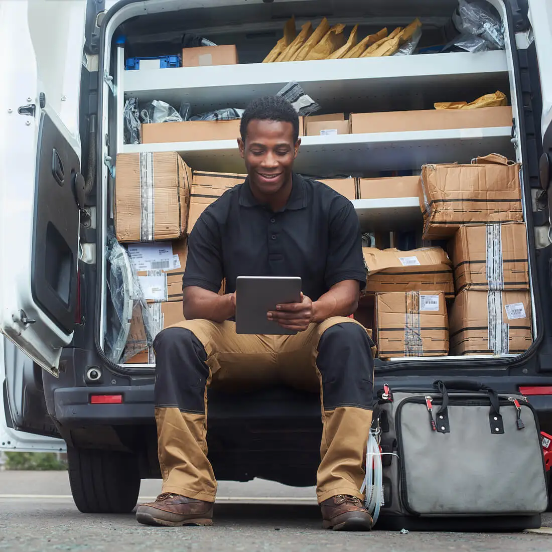 equipment worker sitting on back of work vehicle
