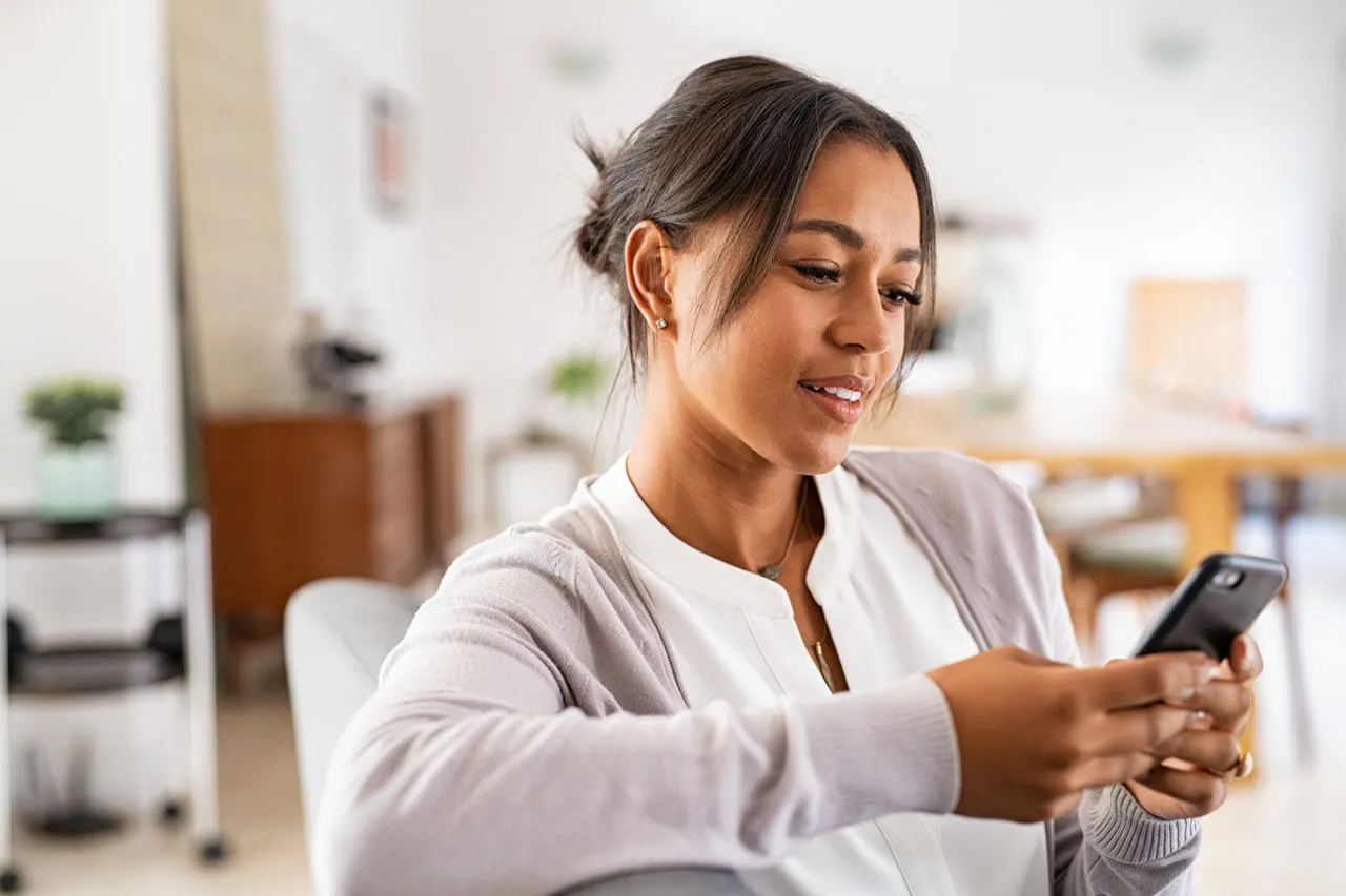 woman on phone looking at online banking