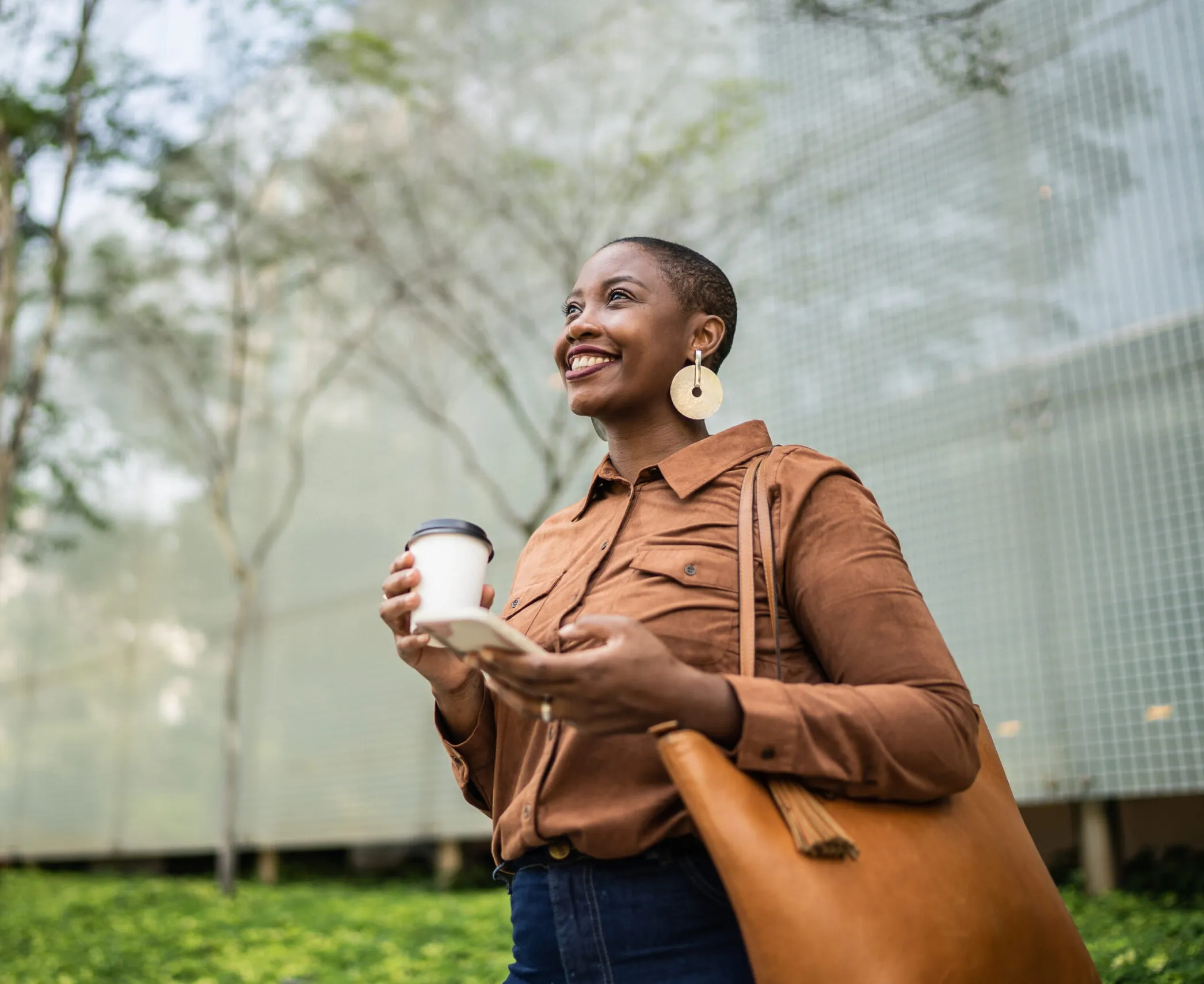 woman smiling with phone and coffee