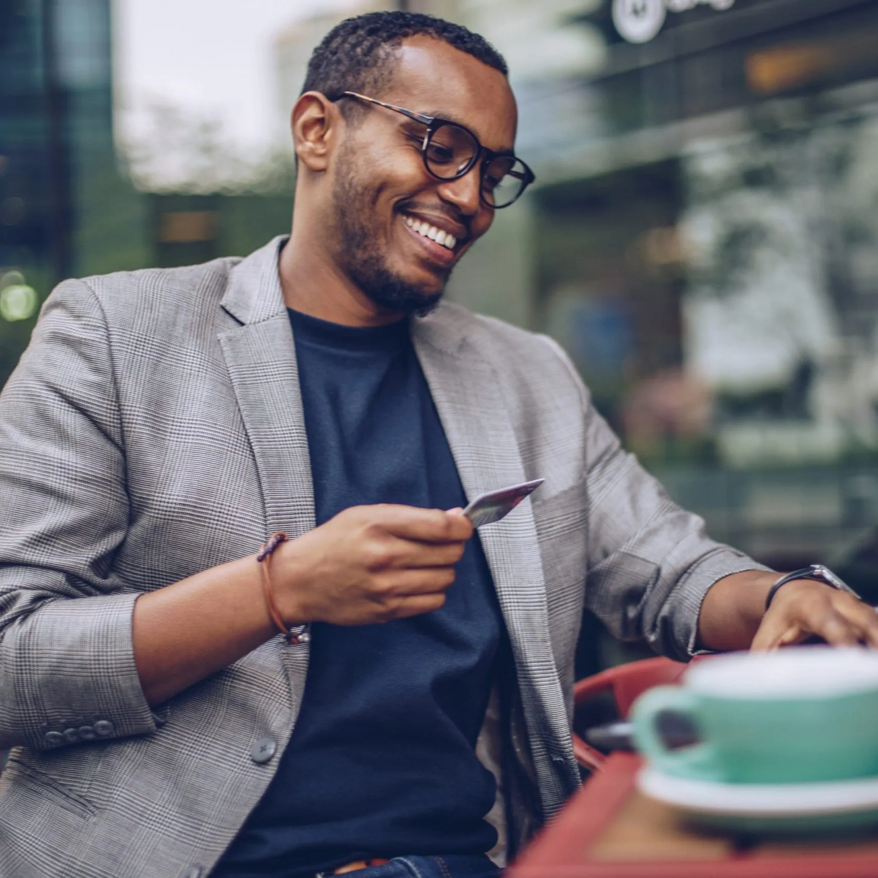 man at coffee shop with debit card